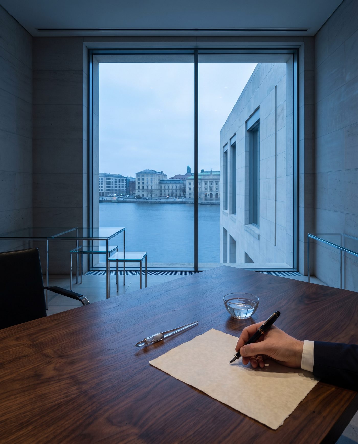 A note being written at a walnut desk, pen visible, hand not the subject.